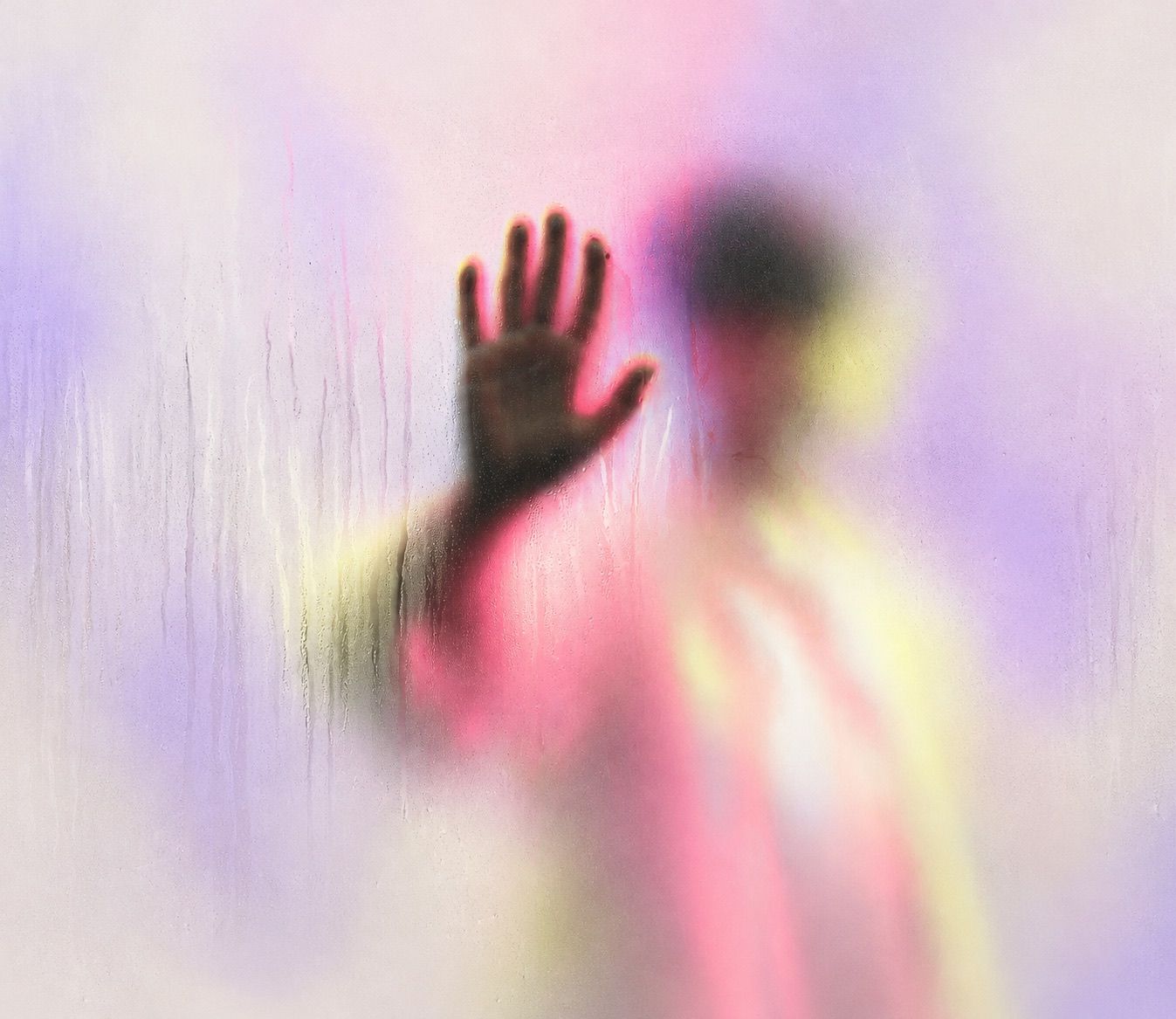 A figure behind misted glass, one hand pressed against it
